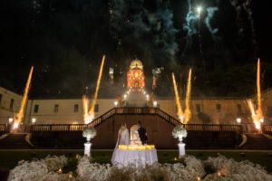 Italian Wedding elegant detail Villa Selvatico night cake setup flowers candles fireworks