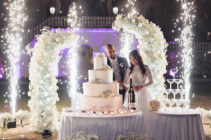 Italian Wedding Villa Selvatico elegant cake setup flower arch lights